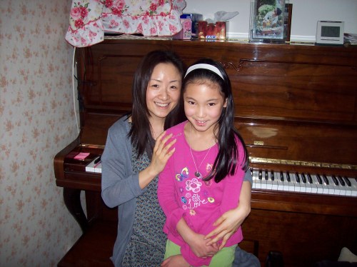 Grace with her piano teacher