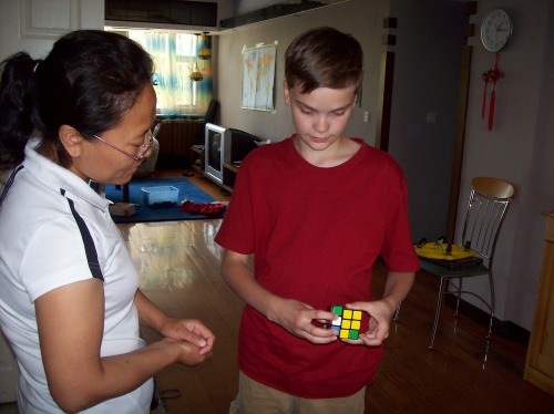 Daniel explaining the Rubik's cube to his Chinese teacher 